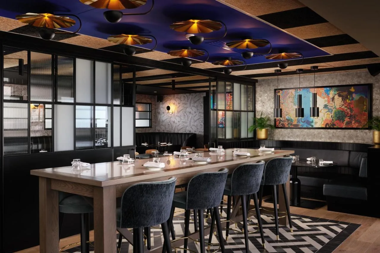 a dining room with a long table and chairs at Malmaison York in York